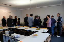 The photo shows several participants of the Departmental Research Day continuing their discussions over drinks and snacks during the break.