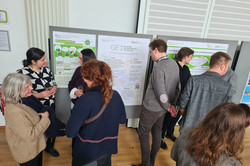 Participants of the Departmental Research Day look at the posters and exchange ideas together.