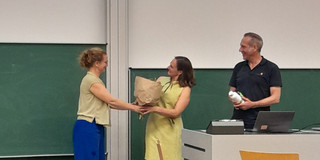 Professor Martina Brandt welcomes Professor Anita Tisch with a bouquet of flowers.