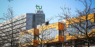 Math tower and cafeteria The cafeteria and the math tower with the logo of TU Dortmund University on top and blue sky in the background