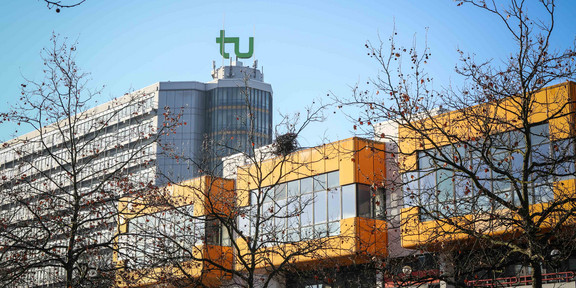 Math tower and cafeteria The cafeteria and the math tower with the logo of TU Dortmund University on top and blue sky in the background