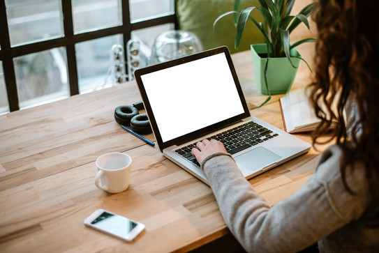 over-the-shoulder shot of person sitting at laptop